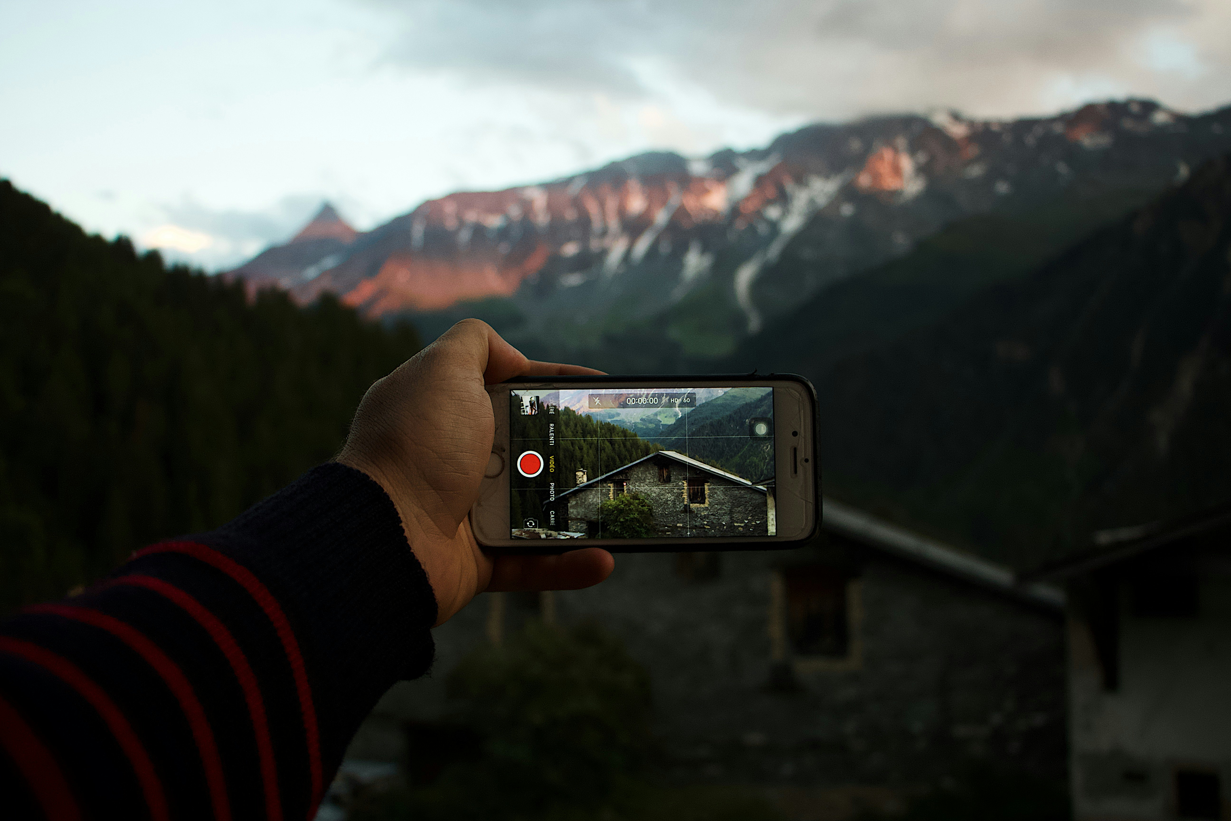 person taking digital image of mountain. Credit: Mael Balland via unsplash